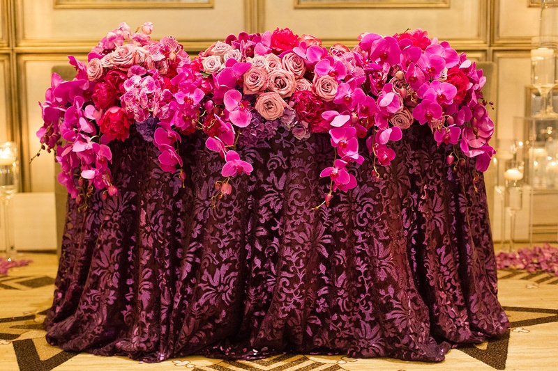 Pink and Purple Floral Arrangements Atop Deep-Colored Linen
Photography: Katie Stoops Photography
Read More:
http://www.insideweddings.com/weddings/bright-playful-oceanfront-wedding-with-delectable-four-course-menu/757/ pink and purple floral arrangements orchids roses linens reception cascading