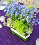 Short Floral Arrangement
Photography: Hoffmann Photographer
Read More:
http://www.insideweddings.com/weddings/colorful-summer-wedding-at-st-regis-monarch-beach/361/ Crystal-wrapped rectangular vase with blue flowers