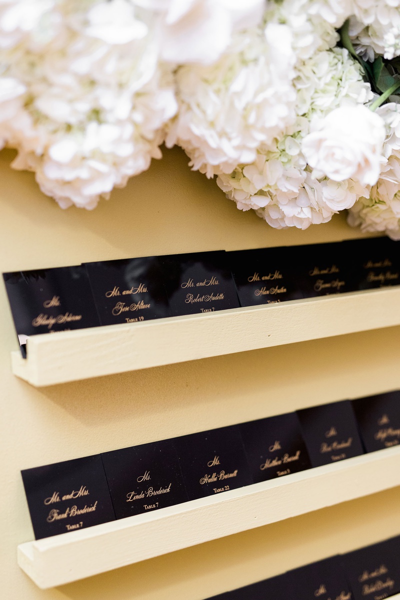 Black %26 Gold Chic Escort Cards
Photography: Brett Hickman Photographers
Read More:
http://www.insideweddings.com/weddings/charlise-castro-and-george-springer-iii/1165/ wedding reception escort card glossy black paper with gold calligraphy on floating shelf flowers