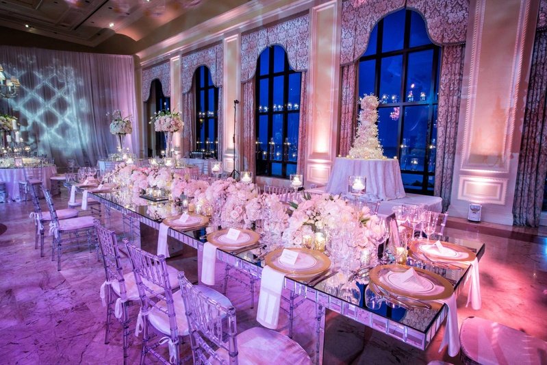 Mirror Long Table with Clear Chairs
Photography: Muñoz Photography
Read More:
http://www.insideweddings.com/weddings/colorful-jewish-ceremony-ballroom-reception-at-the-breakers/818/ The Breakers wedding reception mirror table with gold chargers, low tulip rose hydrangea centerpiece