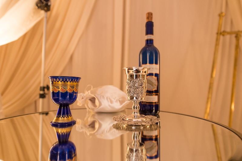 Silver Kiddush Cup for Ceremony
Photography: Carasco Photography
Read More:
http://www.insideweddings.com/weddings/jewish-wedding-with-classic-ivory-and-gold-decor-in-chicago/983/ blue and gold cup and wine bottle, silver kiddush cup, jewish wedding