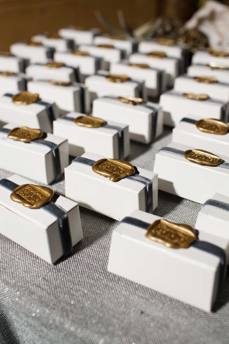 Favor Boxes with Gold Wax Seals
Photography: Perez Photography
Read More:
http://www.insideweddings.com/weddings/incredible-tented-ceremony-barn-reception-at-ranch-in-aspen/860/ Personalized boxes with ribbon, wax seal filled with artisan chocolates from Dallas chocolatier
