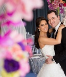 Newlyweds at Reception
Photography: Fred Marcus Studio
Read More:
http://www.insideweddings.com/weddings/pink-purple-garden-inspired-tented-wedding-in-new-york/624/ Bride in a strapless Monique Lhuillier dress hugs groom in black tuxedo at reception