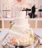 White Cake with Mr. %26 Mrs. Cursive Topper
Photography: Switzerfilm
Read More:
http://www.insideweddings.com/weddings/rooftop-ceremony-with-city-views-dreamy-reception-in-st-louis/844/ Wedding cake with fondant layer, pearls, rose base with fresh flowers and Mr. Mrs. cake topper