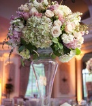 Tall Centerpiece
Photography: Images by Berit, Inc.
Read More:
http://www.insideweddings.com/weddings/classic-pink-castle-wedding-in-new-jersey/340/ Wedding reception centerpiece of white, green, pink, and light purple flowers in a tall glass vase
