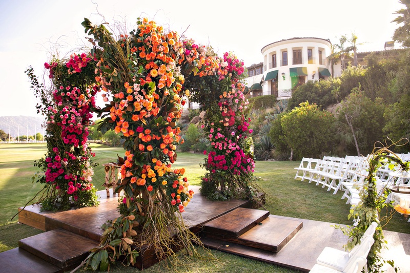 Pink %26 Orange Floral Chuppah
Photography: Laurie Bailey Photography
Read More:
http://www.insideweddings.com/weddings/outdoor-jewish-ceremony-reception-with-colorful-bohemian-decor/1330/ wedding ceremony wood aisle outdoor chuppah with colorful color palette pink orange flowers