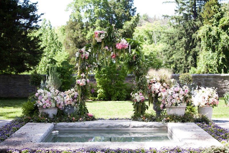 Custom Garden-Inspired Arch at Ohio Venue
Photography: Michael Bambino %26 Co.
Read More:
http://www.insideweddings.com/weddings/whimsical-open-air-secret-garden-wedding-with-soft-spring-hues/777/ a custom secret garden inspired arch with dripping greenery and pink and purple flowers