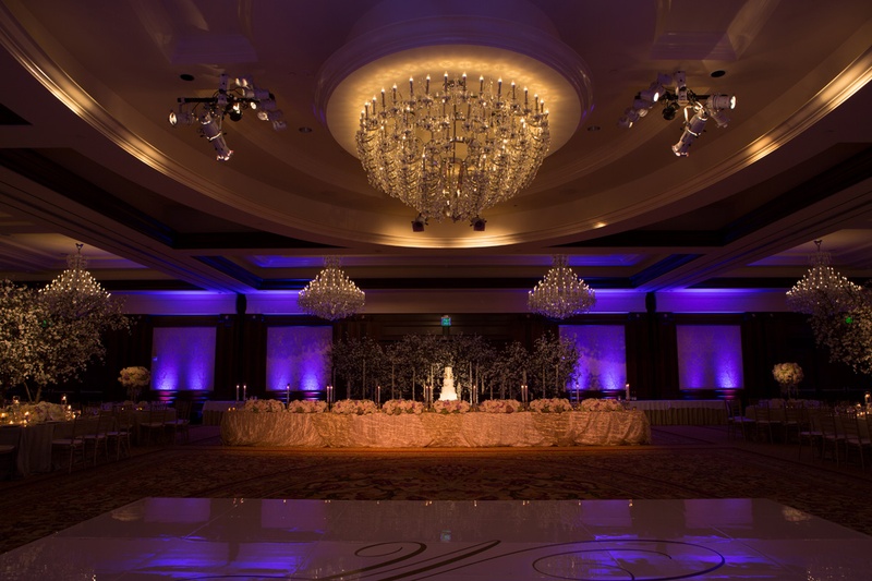 Room Shot at Four Seasons Wedding
Photography: Jay Lawrence Goldman Photography
Read More:
http://www.insideweddings.com/weddings/elegant-white-lavender-ballroom-wedding-with-cherry-blossom-trees/710/ Ballroom wedding with purple lighting, cake, and custom dance floor