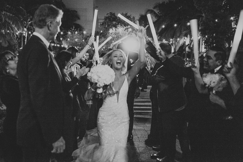 Happy Bride During Grand Exit
Photography: Jimmy Bui Photography
Read More:
http://www.insideweddings.com/weddings/elegant-edgy-wedding-inspired-by-disney-at-vibiana-in-downtown-la/1229/ black and white photo of bride with bouquet as guests wave neon light up sticks celebration