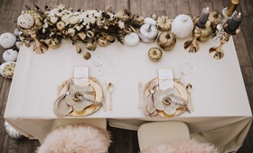 Aerial View of Sweetheart Table
Photography: Atelier Kryjak
Read More:
http://www.insideweddings.com/weddings/autumn-glamour-inspirational-shoot-with-gilded-pumpkin-decor/1185/ Wedding reception sweetheart table gold pumpkin white pumpkin charcoal candle on gold candlestick
