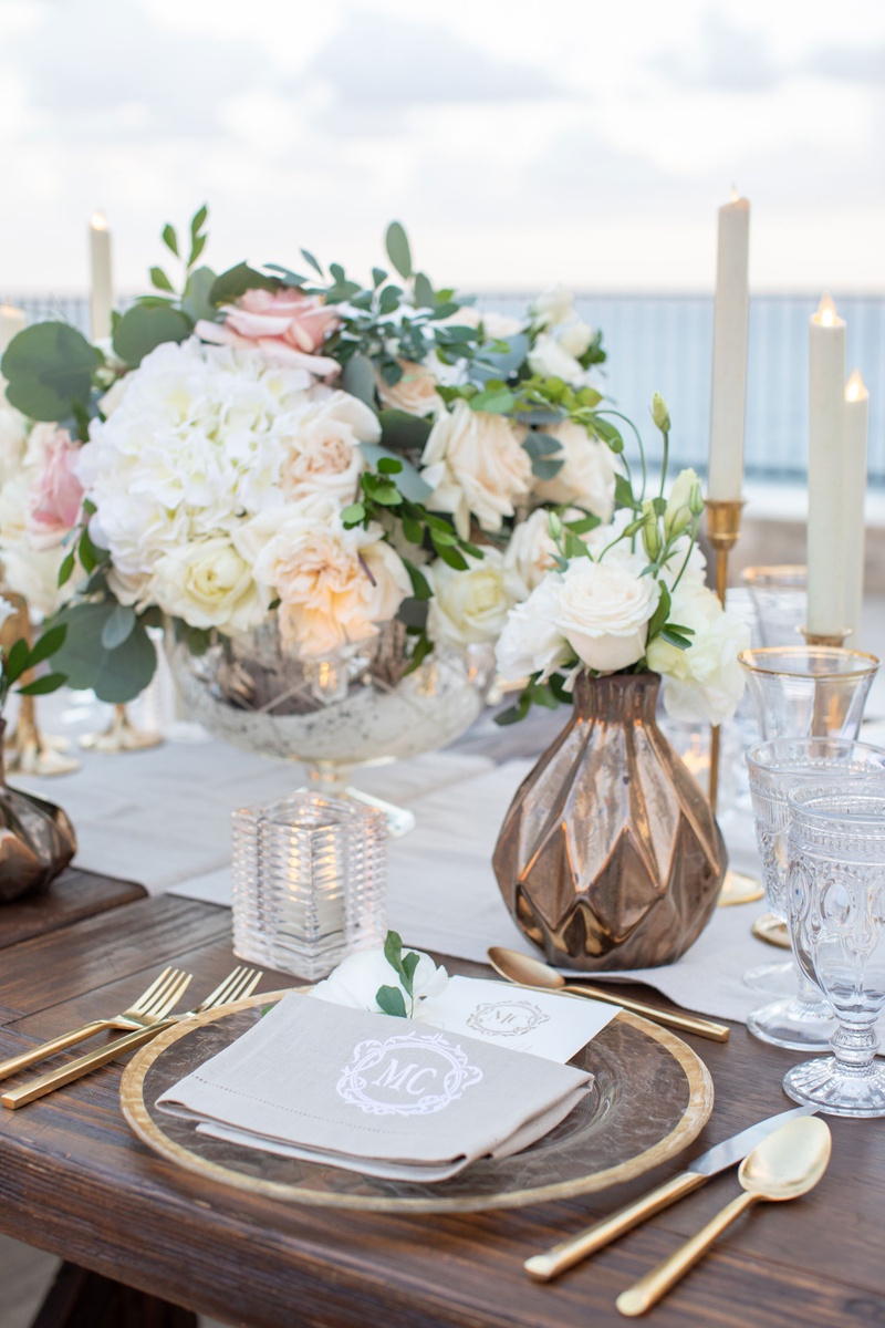 Romantic Décor at Oceanfront Reception
Photography: Collin Pierson Photography
Read More:
http://www.insideweddings.com/weddings/beach-wedding-ceremony-romantic-reception-inspiration-in-cabo/1304/ wedding reception wood table gold flatware charger white hydrangea pink rose bronze vase crystal