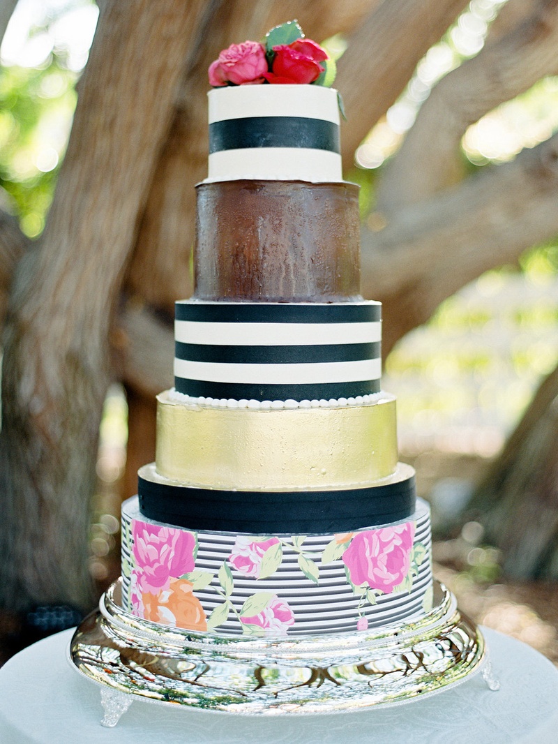 Whimsical Cake with Stripes and Flowers
Photography: Ryan Ray Photography
Read More:
http://www.insideweddings.com/weddings/outdoor-wedding-with-vibrant-pink-orange-decor-in-california/723/ Whimsical wedding cake with black and white stripes, gold, and flower print decorations