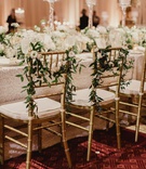 Greenery on Bride %26 Groom's Gold Chairs
Photography: Shaun Menary Photography
Read More:
http://www.insideweddings.com/weddings/luxurious-hotel-wedding-texas-fair-themed-after-party-in-dallas/1241/ wedding reception gold chair with greenery and flowers white cushions head table ballroom carpet