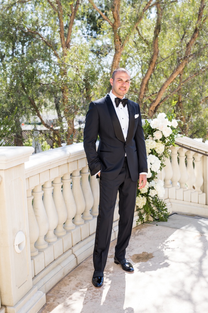 Groom in Designer Tuxedo %26 Bow Tie
Photography: Samuel Lippke Studios
Read More:
http://www.insideweddings.com/weddings/outdoor-jewish-wedding-ceremony-luxe-reception-in-california/1160/ Groom on staircase with white flowers tuxedo tom ford bow tie white pocket square