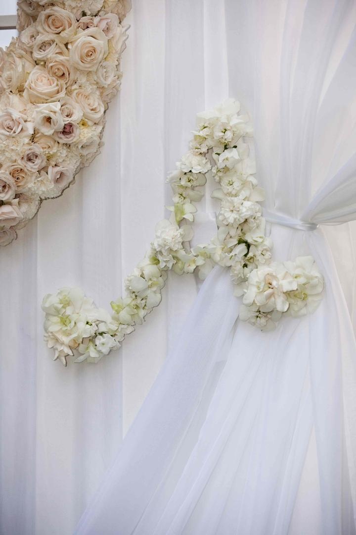 Ceremony Floral Initial
Photography: Lauren Ross Photography %26 Nancy Cohn Photography
Read More:
http://www.insideweddings.com/weddings/sophisticated-breakers-wedding-with-pink-florals/335/ White ceremony drapes tied with flower initial