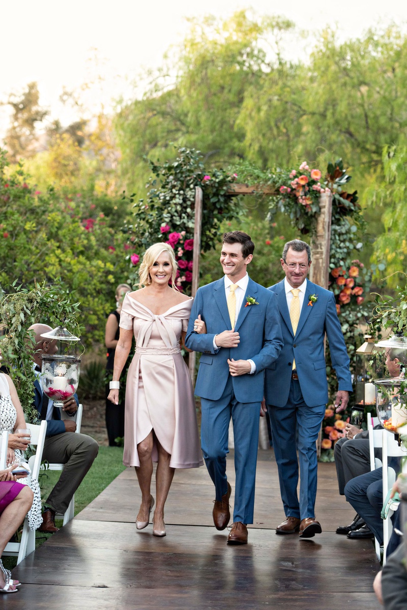 Groom with Father %26 Mother on Wood Aisle
Photography: Laurie Bailey Photography
Read More:
http://www.insideweddings.com/weddings/outdoor-jewish-ceremony-reception-with-colorful-bohemian-decor/1330/ wedding ceremony processional groom with father matching suit tie and mother elie saab pink gown