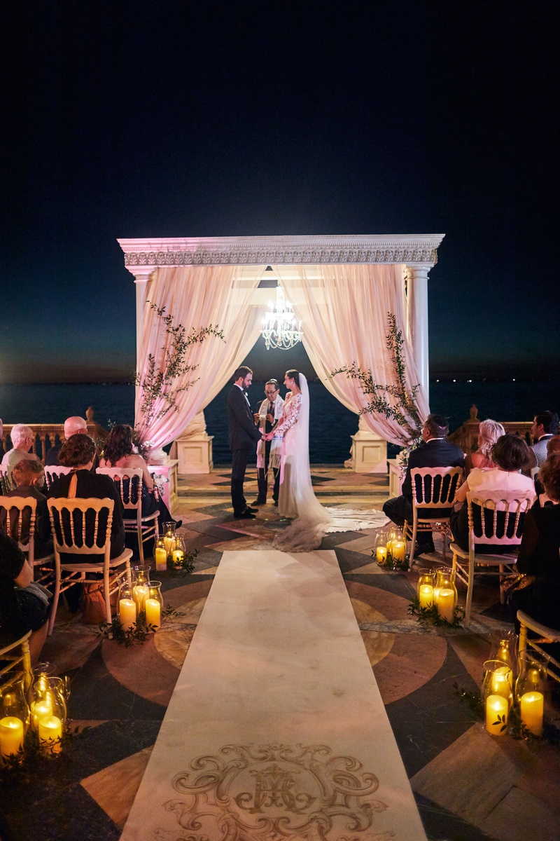 Nighttime Ceremony with Chandelier
Photography: Binaryflips Photography
Read More:
http://www.insideweddings.com/weddings/bayfront-ceremony-garden-courtyard-reception-in-sarasota-florida/1344/ jewish ceremony after sunset with chandelier under chuppah for lighting