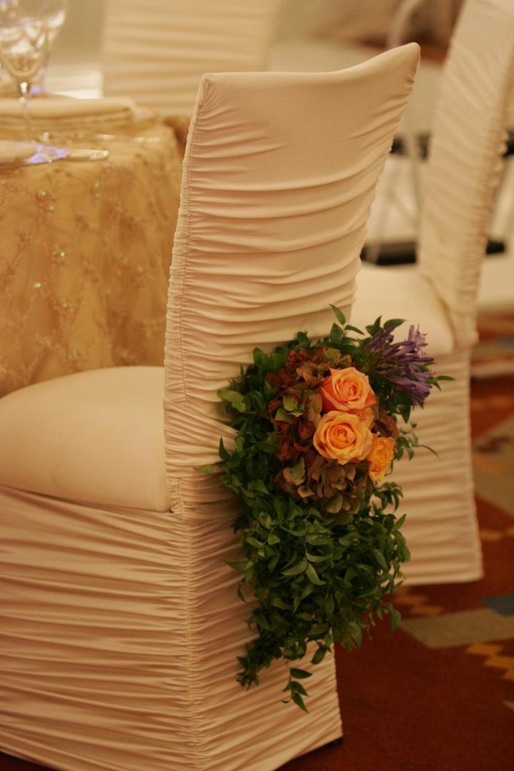 Floral-Embellished Chair
Photography: Lyn Sims Photographer
Read More:
http://www.insideweddings.com/weddings/glamorous-fall-wedding-with-garden-touches-in-tucson-arizona/258/ Ruched ivory chair covers at reception