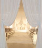 Draped Ceremony Entrance
Photography: Bob %26 Dawn Davis Photography
Read More:
http://www.insideweddings.com/weddings/modern-purple-blue-white-wedding-at-contemporary-chicago-venue/541/ All-white wedding ceremony with chiffon drapery and candles
