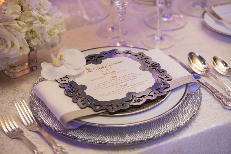 Orchid Atop Laser-Cut Menu
Photography: Collin Pierson Photography
Read More:
http://www.insideweddings.com/weddings/winter-wedding-inspirational-shoot-with-opulent-frosted-decor/1108/ Wedding reception place setting silver laser cut menu card white orchid rose hydrangea centerpiece