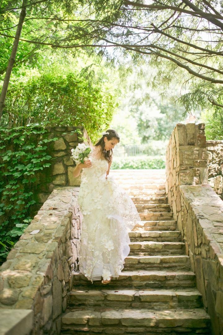 Unique Romantic Gown
Photography: Harwell Photography
Read More:
http://www.insideweddings.com/weddings/romantic-woodland-inspired-atlanta-wedding-with-natural-details/433/ Bride walks on stone steps with flower motif dress