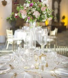 Tall Floral Centerpiece on Round Table
Photography: Lane Dittoe Photography
Read More:
http://www.insideweddings.com/weddings/romantic-garden-party-inspired-summer-wedding-at-a-country-club/967/ Wedding reception round table gold flatware and charger plate tall centerpiece in glass vase candles