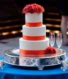 Orange %26 White Cake
Photography: Zuma Photo
Read More:
http://www.insideweddings.com/weddings/modern-outdoor-wedding-in-park-city-utah/420/ Wedding cake on silver stand on blue table with orange ribbons