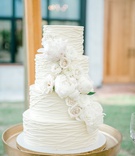 Fresh Roses %26 Peonies on Cake
Photography: Jennings King Photography
Read More:
http://www.insideweddings.com/weddings/alfresco-spring-destination-wedding-in-charleston-south-carolina/1277/ wedding cake four layer white cake with white rose and peony flowers gold stand textured