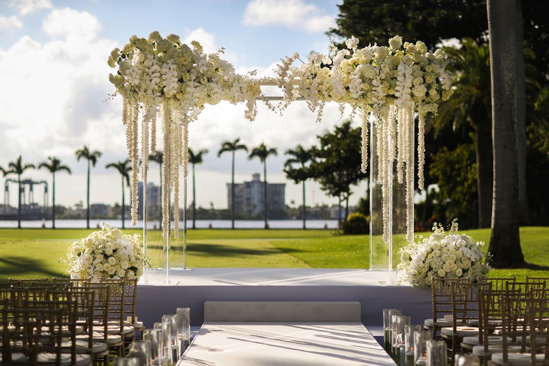 Ivory Orchid %26 Acrylic Ceremony Arch
Photography: Alain Martinez Photography
Read More:
http://www.insideweddings.com/weddings/opulent-luxury-wedding-with-white-gold-color-scheme-in-palm-beach/1375/ acrylic wedding ceremony arch white orchid and cascading flowers rose hydrangea arrangements candles