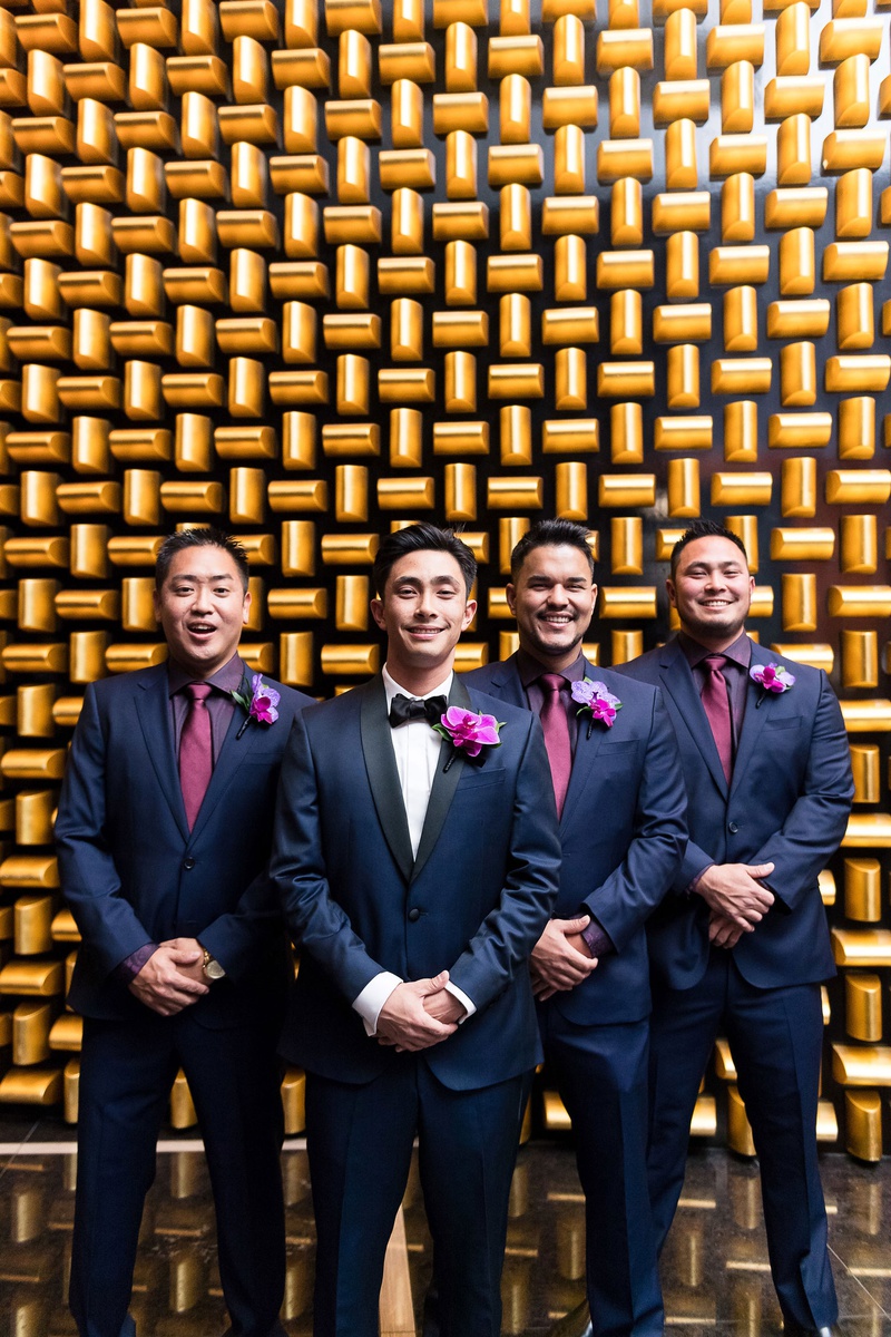 Groom and Groomsmen in Navy
Photography: Brian Leahy Photography
Read More:
http://www.insideweddings.com/weddings/a-hawaiian-couples-luxurious-destination-wedding-in-las-vegas/1226/ groom in navy tuxedo with black lapels, groomsmen in navy suits, purple shirts, fuchsia ties