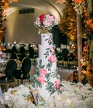 Floral Cake on Bed of Flowers
Photography: Jessica Claire Photography
Read More:
http://www.insideweddings.com/weddings/50th-anniversary-party-with-fall-foliage-and-unique-performances/1068/ 5-tier wedding cake with pink flower and greenery on bed of white flowers