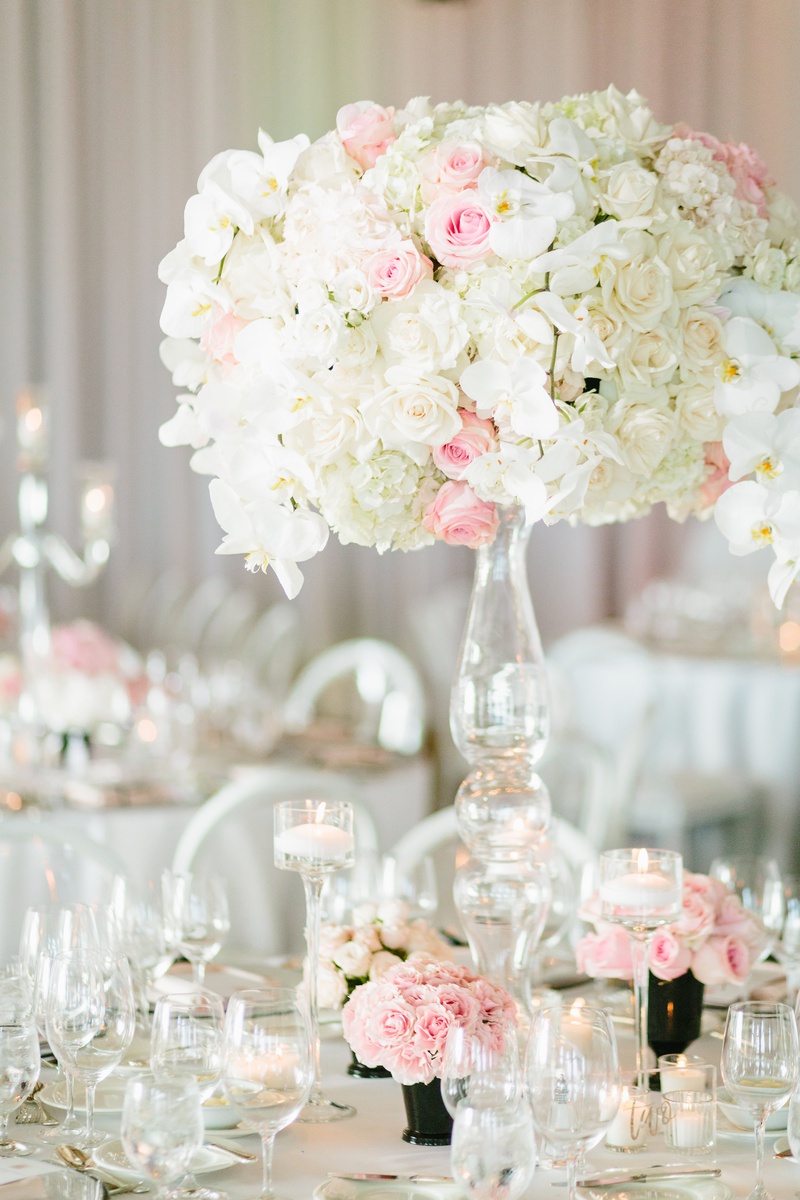 Lush Centerpiece on Crystal Stand
Photography: Jodee Debes Photography
Read More:
http://www.insideweddings.com/weddings/elegant-alfresco-ceremony-reception-with-parisian-elements/1176/ wedding reception centerpiece with ivory roses, pink roses, and white orchids