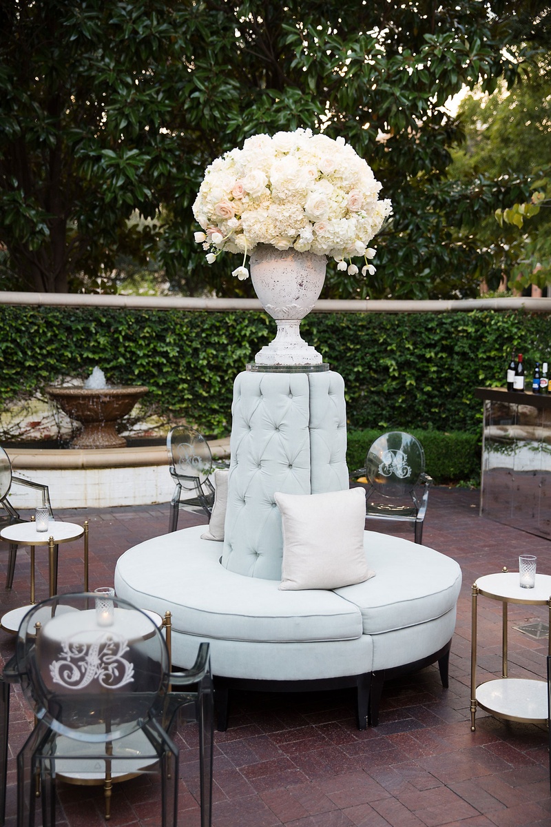 Cocktail Hour Settee with Flowers
Photography: Sarah Kate, Photographer
Read More:
http://www.insideweddings.com/weddings/outdoor-fall-ceremony-opulent-tented-reception-in-dallas-texas/1022/ Flower arrangement on top of round settee tufted pillow monogram on ghost chairs side tables candles