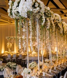 Towering Cascading Floral Centerpiece
Photography: Genevieve Nisly Photography
Read More:
http://www.insideweddings.com/weddings/new-years-eve-wedding-with-a-dreamy-winter-wonderland-theme/1258/ wedding reception tall silver riser white rose orchid flowers amaranthus glass orb candlelight tulip