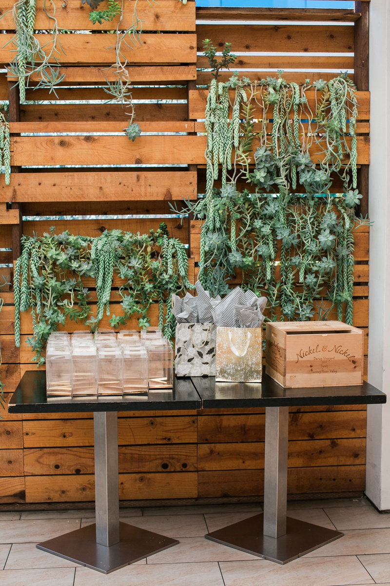 Guest Table with Succulents
Photography: Jessica Claire Photography
Read More:
http://www.insideweddings.com/weddings/unique-chic-bridal-shower-with-dark-and-moody-color-scheme/1335/ bridal shower guest table in front of wood pallet wall with succulents dripping down