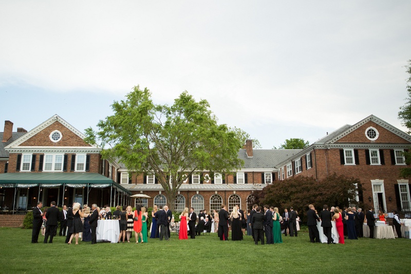 Country Club Cocktail Hour
Photography: Aaron Watson Photography
Read More:
http://www.insideweddings.com/weddings/classic-virginia-wedding-inspired-by-grace-kellys-elegance/511/ Wedding guests on grass lawn in front of brick country club