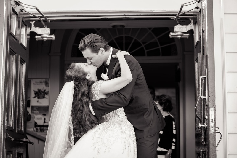 Couple Shares Kiss After Ceremony
Photography: Magnolia Studio
Read More:
http://www.insideweddings.com/weddings/charming-church-ceremony-romantic-ballroom-reception-in-quebec/1075/ Black and white photo of bride and groom kissing on outside of church doors after ceremony veil long