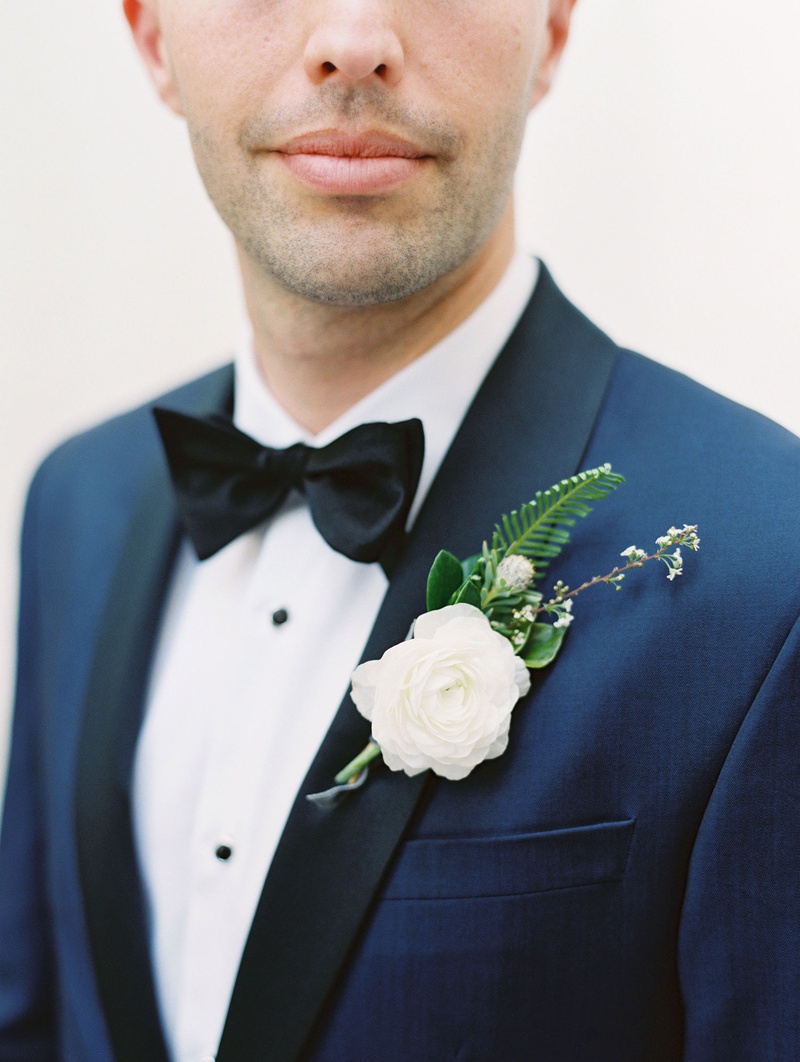 White Boutonniere on Navy Jacket
Photography: Mallory Dawn Photography
Read More:
http://www.insideweddings.com/weddings/outdoor-jewish-ceremony-luxe-reception-at-vibiana-in-downtown-la/1259/ groom with navy tuxedo jacket black lapels white ranunculus flower fern greenery boutonniere