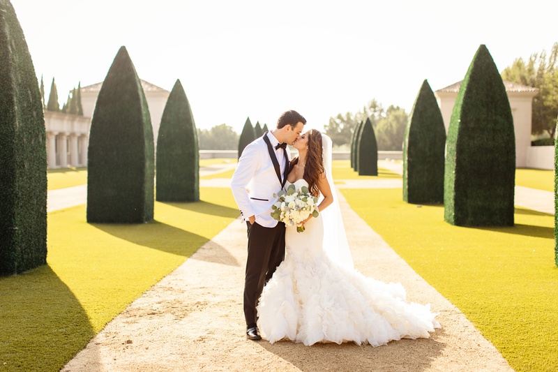 Couple on Manicured Pathway
Photography: Chard Photo
Read More:
http://www.insideweddings.com/weddings/alfresco-ceremony-on-the-coast-classic-ballroom-reception/1290/ bride in ines di santo mermaid wedding dress with ruffles, groom in white tuxedo jacket