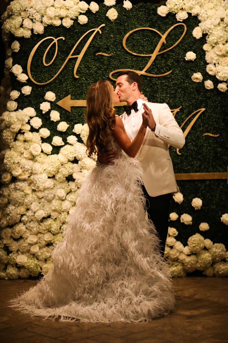 Couple In Front of Hedge Seating Chart
Photography: Alain Martinez Photography
Read More:
http://www.insideweddings.com/weddings/opulent-luxury-wedding-with-white-gold-color-scheme-in-palm-beach/1375/ bride in second wedding dress ostrich feather skirt kissing groom in front of hedge wall chart
