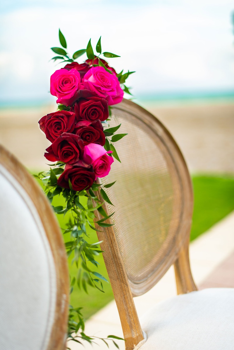 Pink %26 Red Roses on Ceremony Chair
Photography: Suzanne Delawar Studios
Read More:
http://www.insideweddings.com/weddings/intimate-oceanfront-wedding-with-romantic-red-pink-white-palette/1235/ wedding ceremony chair white cushion wood cane back pink red roses greenery