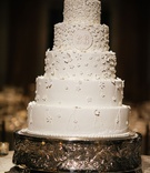 Five Layer Cake with White Flowers
Photography: Chris Bailey Photography
Read More:
http://www.insideweddings.com/weddings/sophisticated-southern-soiree-in-texas-with-an-ode-to-new-orleans/1093/ Five layer traditional white wedding cake with sugar flowers design on white cake monogram on tier