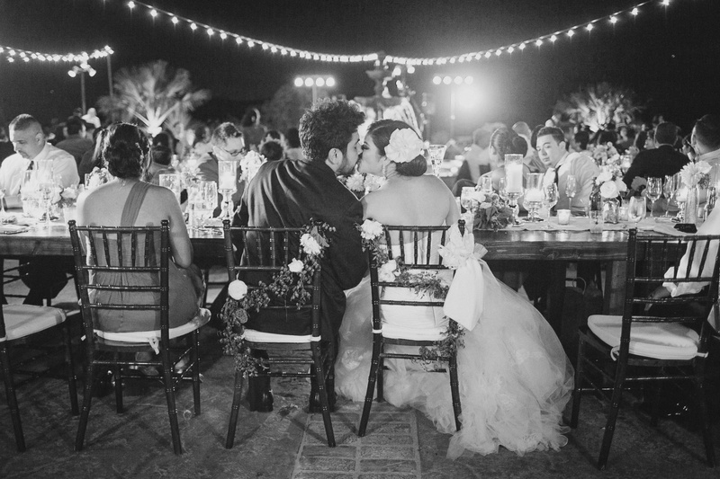 Romantic Alfresco Reception
Photography: Jasmine Star Photography
Read More:
http://www.insideweddings.com/weddings/spanish-style-ceremony-outdoor-ranch-wedding-reception/504/ Black and white photo of bride and groom kissing at outdoor reception