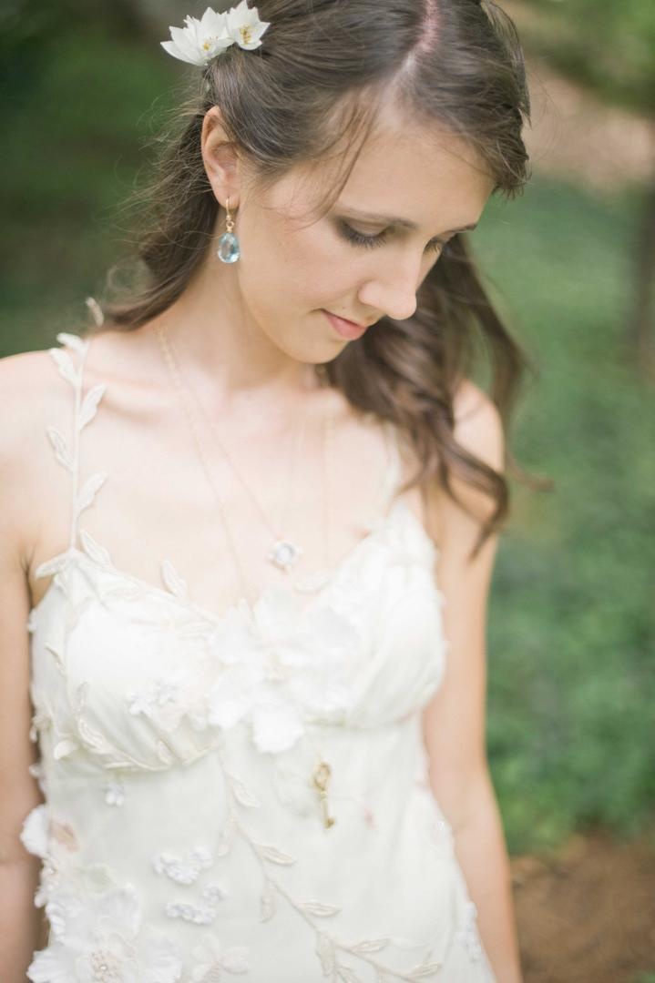 Romantic Bridal Accessories
Photography: Harwell Photography
Read More:
http://www.insideweddings.com/weddings/romantic-woodland-inspired-atlanta-wedding-with-natural-details/433/ Bride wearing light blue earrings and key necklace