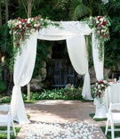Chuppah in Front of Waterfall
Photography: David Manning Photographer
Read More:
http://www.insideweddings.com/weddings/interfaith-ceremony-tented-reception-with-romantic-color-palette/885/ chuppah with greenery and red, blush, and ivory florals, rose petal aisle, waterfall