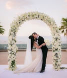 Floral Arch with View at Wedding
Photography: Lin %26 Jirsa Photography
Read More:
http://www.insideweddings.com/weddings/gorgeous-outdoor-ceremony-ballroom-reception-in-rancho-mirage/996/ Outdoor wedding ceremony bride and groom kissing galia lahav dress white flowers palm trees
