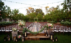 Raised Wooden Ceremony Space Outdoors
Photography: Paul Barnett Photographer
Read More:
http://www.insideweddings.com/weddings/bohemian-outdoor-garden-wedding-ceremony-rustic-reception/830/ raised platform jewish wedding ceremony greenery small candles lanterns alfresco