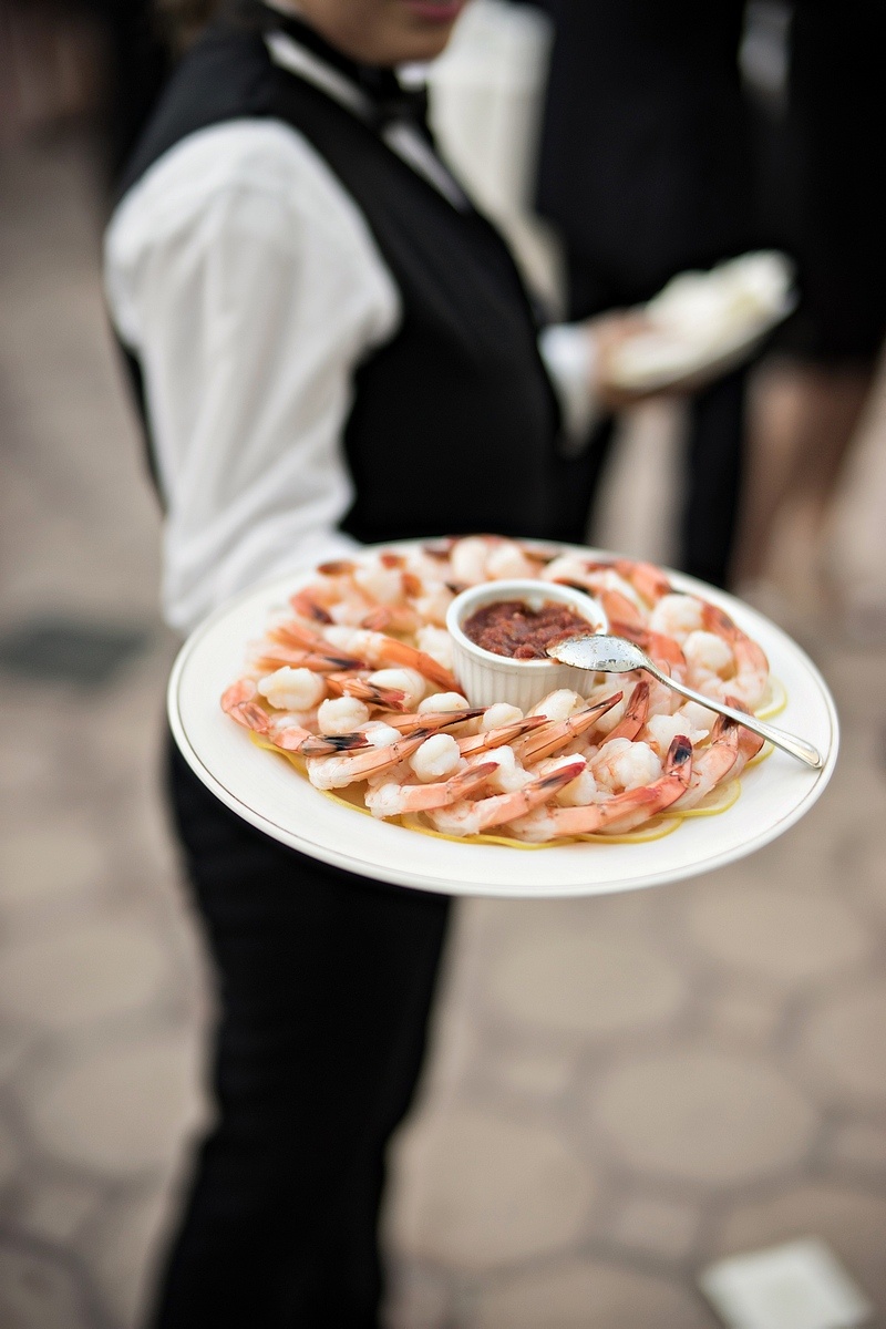 Shrimp Plate at Cocktail Hour
Photography: Laurie Bailey Photography
Read More:
http://www.insideweddings.com/weddings/oceanfront-wedding-ceremony-classic-romantic-ballroom-reception/854/ server with platter of shrimp at wedding cocktail hour