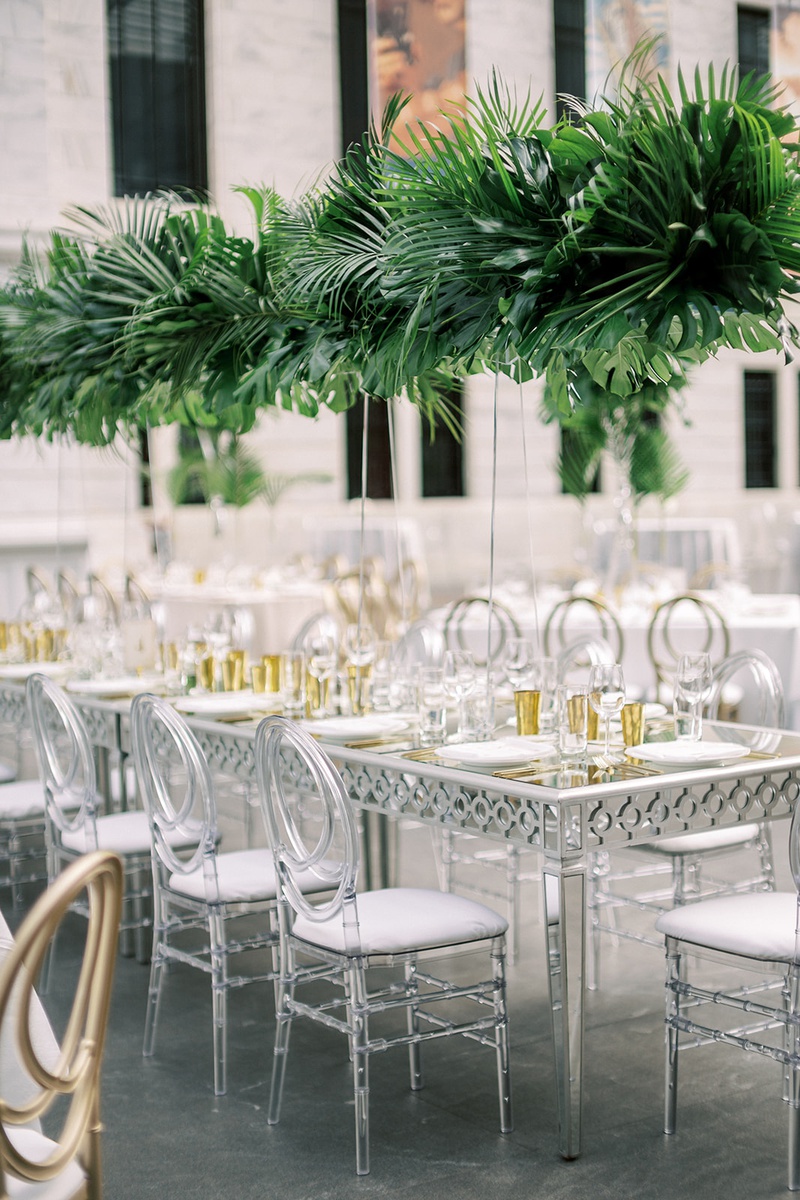 Lucite Chair at Silver %26 Mirror Table
Photography: Lauren Gabrielle Photography
Read More:
http://www.insideweddings.com/weddings/summer-real-wedding-featuring-tropical-decor-at-an-art-museum/1328/ wedding reception long silver and mirror table with oval lucite acrylic chairs tall tropical