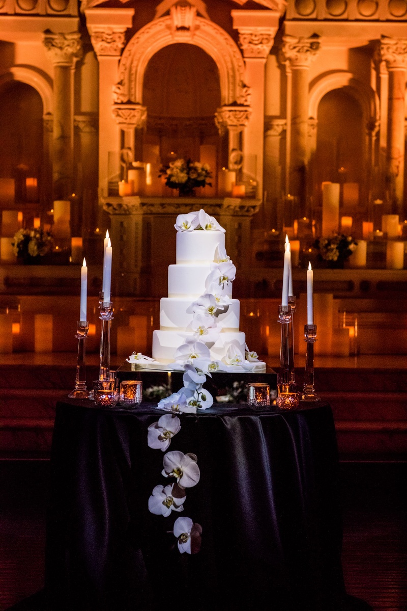 Buttercream Cake with Fresh Orchids
Photography: Kim Fox Photography
Read More:
http://www.insideweddings.com/weddings/luxe-vintage-inspired-winter-wedding-in-downtown-los-angeles/1082/ Four layer wedding cake on black table candlesticks orchids cascading down front